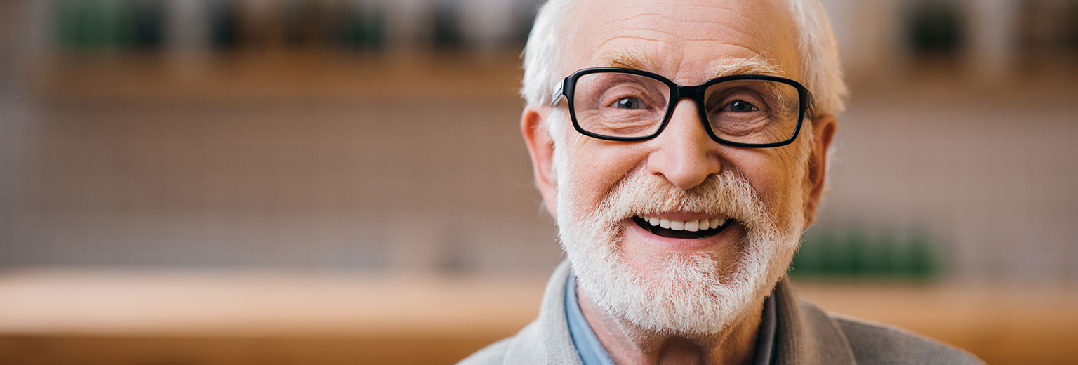 Senior man smiling after Dental Implants